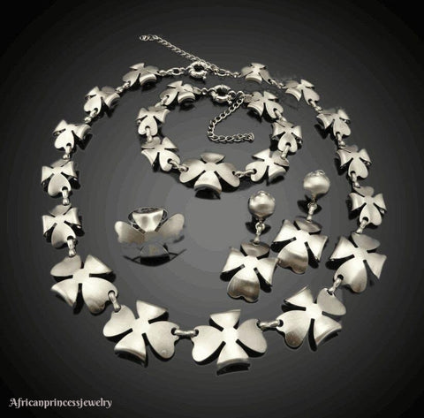 FOUR PIECE 18K WHITE GOLD PLATED SILVER NECKLACE SET.