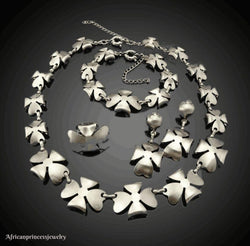 FOUR PIECE 18K WHITE GOLD PLATED SILVER NECKLACE SET.